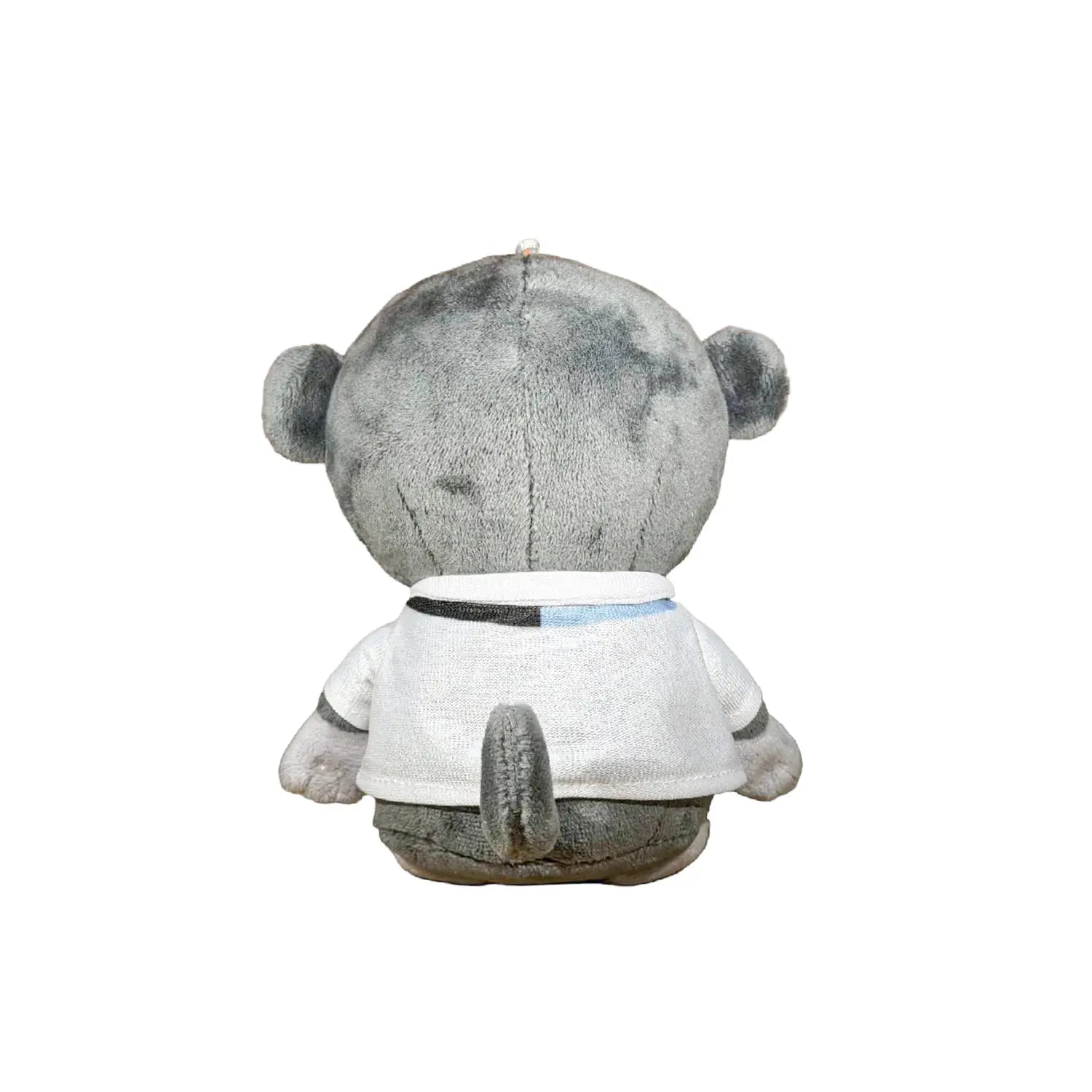 A plush monkey toy wearing a white shirt with black circular graphics and a small blue accent, photographed against a plain white background.